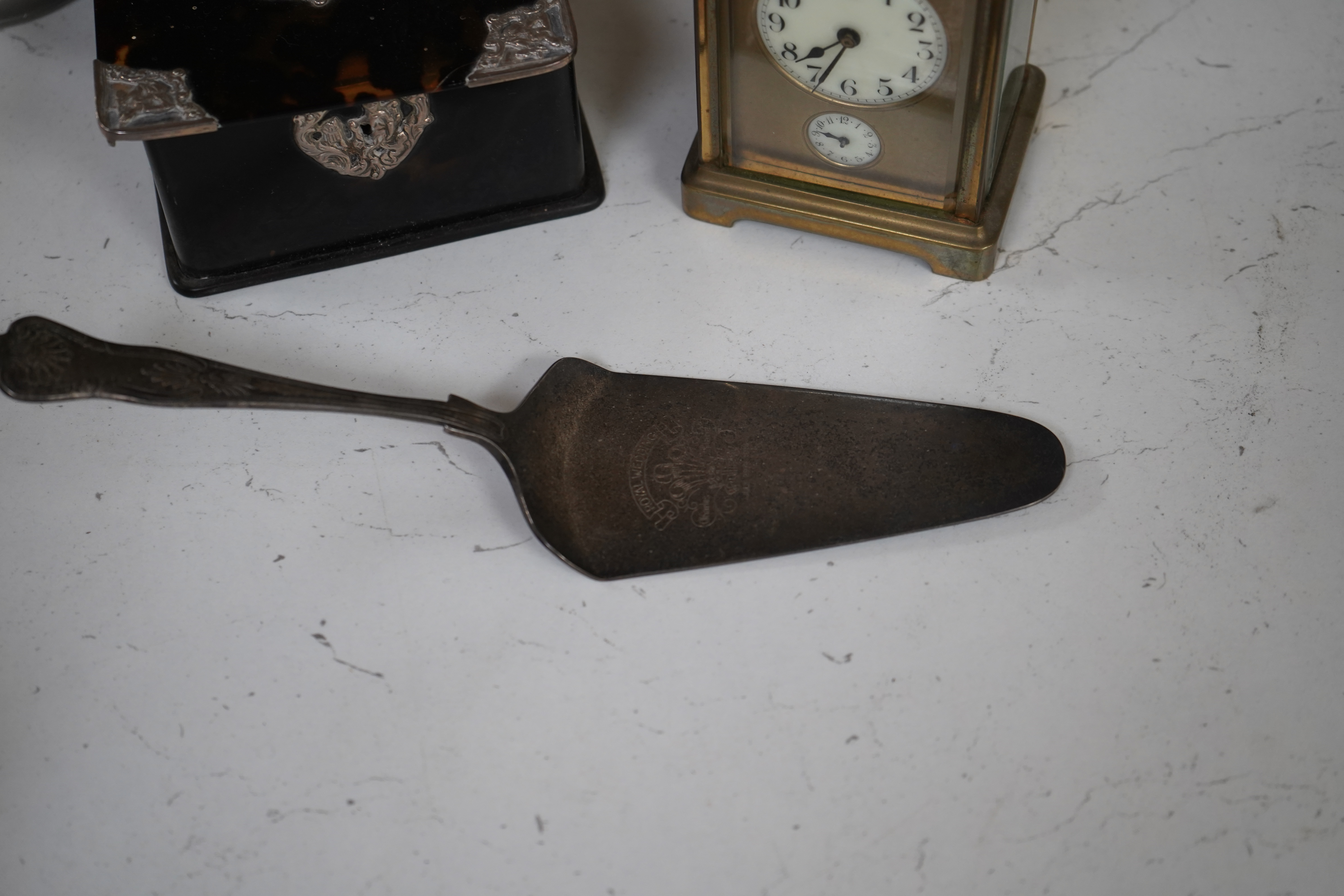 A small collection of metalware to include a white metal mounted tortoiseshell box, brass cased carriage clock with subsidiary dial and a pewter tankard. Condition - poor to fair